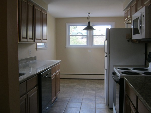 19 Rydal Street Worcester, MA 01602 - Photo 4 of 19 a kitchen with stainless steel appliances granite countertop a stove a refrigerator and a sink