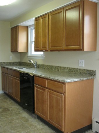 19 Rydal Street Worcester, MA 01602 - Photo 5 of 19 a kitchen with a sink and cabinets