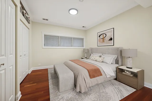 a bedroom with a bed and painting on the wall