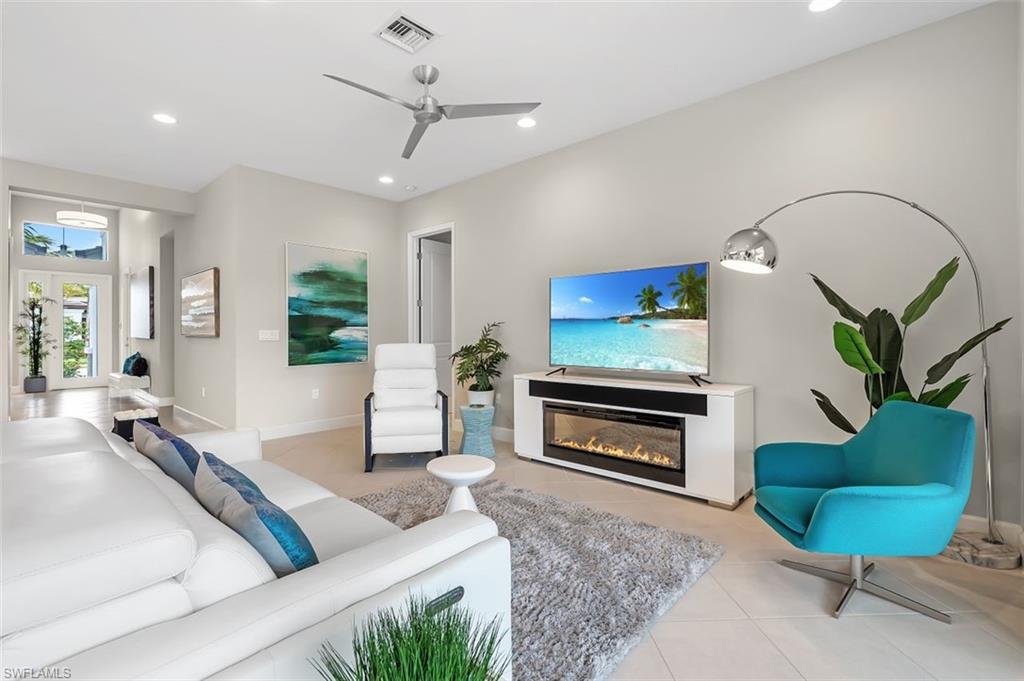 11311 Jacaranda Drive Naples, FL 34120 - Photo 13 of 50 a living room with furniture and a fireplace