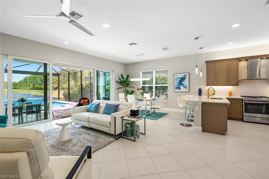 11311 Jacaranda Drive Naples, FL 34120 - Photo 15 of 50 a living room with fireplace furniture and a large window