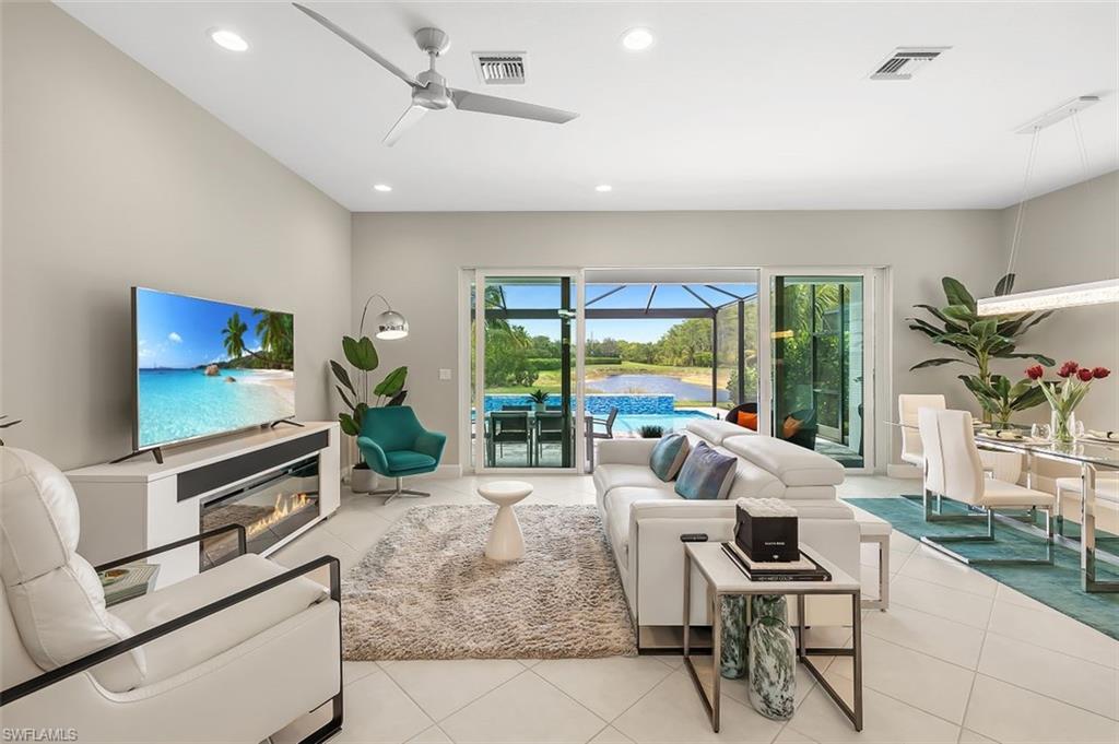 11311 Jacaranda Drive Naples, FL 34120 - Photo 19 of 50 a living room with furniture and a flat screen tv