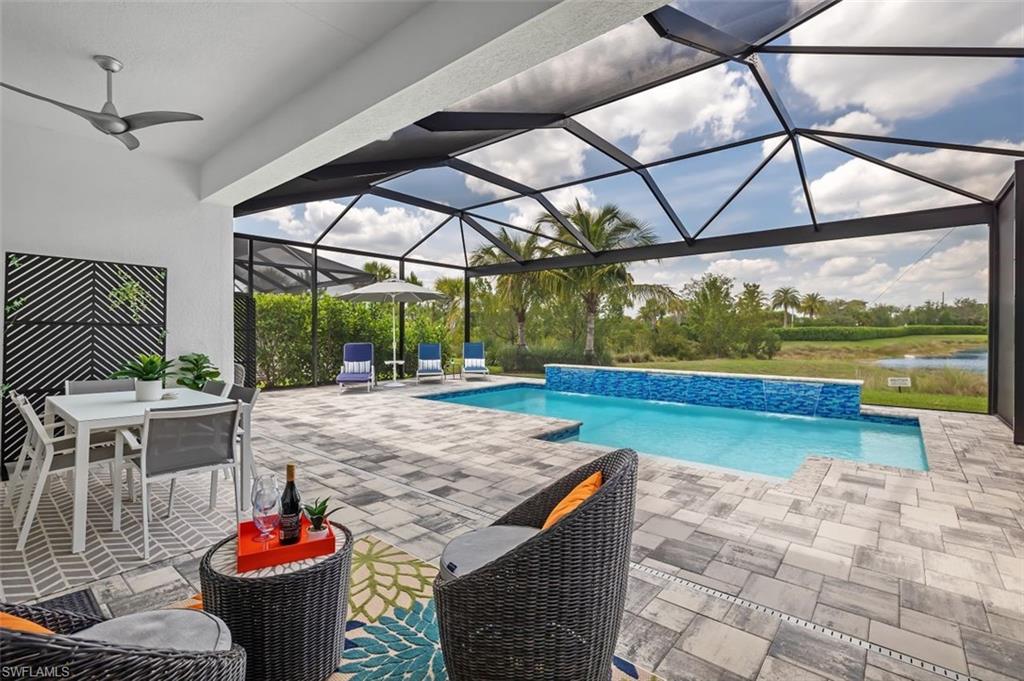 11311 Jacaranda Drive Naples, FL 34120 - Photo 20 of 50 a view of a patio with a table chairs and a table