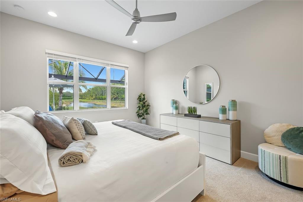 11311 Jacaranda Drive Naples, FL 34120 - Photo 24 of 50 a bedroom with a bed and a large window