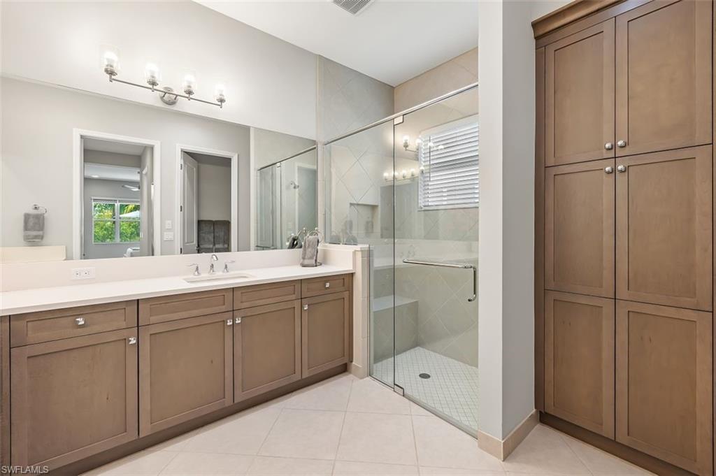 11311 Jacaranda Drive Naples, FL 34120 - Photo 27 of 50 a bathroom with a tub shower and sink