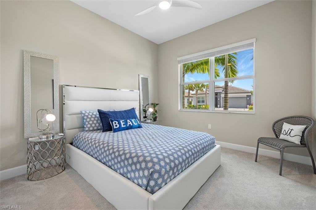 11311 Jacaranda Drive Naples, FL 34120 - Photo 32 of 50 a bedroom with a bed and a window