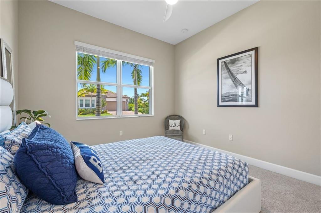 11311 Jacaranda Drive Naples, FL 34120 - Photo 33 of 50 a bedroom with a bed and a window