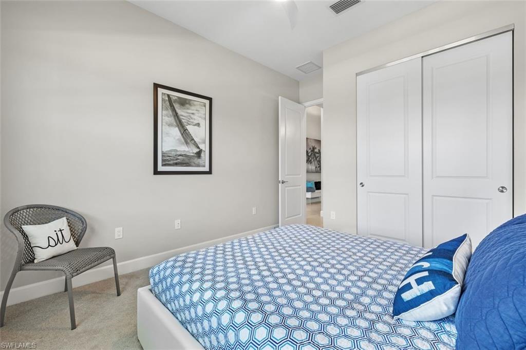 11311 Jacaranda Drive Naples, FL 34120 - Photo 34 of 50 a bedroom with a bed and a chair