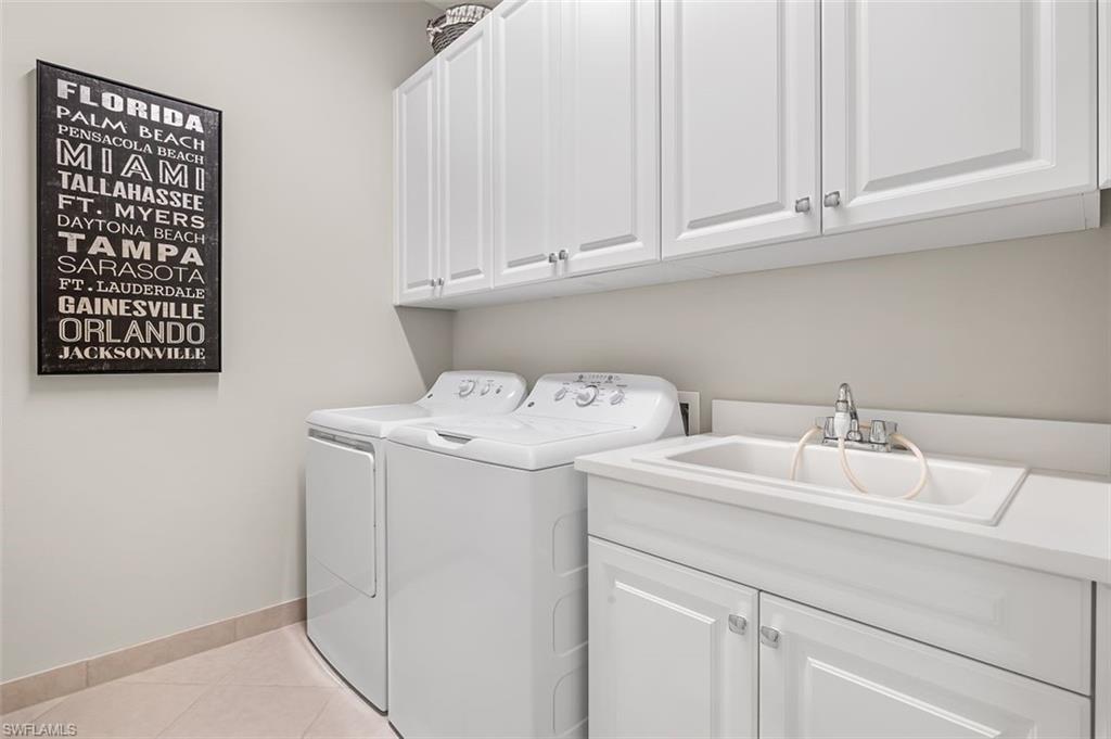 11311 Jacaranda Drive Naples, FL 34120 - Photo 36 of 50 a utility room with dryer and washer