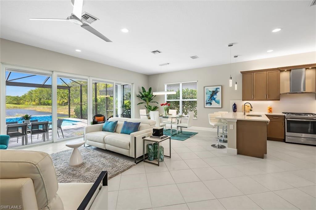 11311 Jacaranda Drive Naples, FL 34120 - Photo 5 of 50 a living room with fireplace furniture and a large window