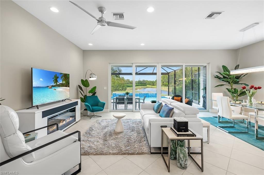11311 Jacaranda Drive Naples, FL 34120 - Photo 9 of 50 a living room with furniture tv and large window