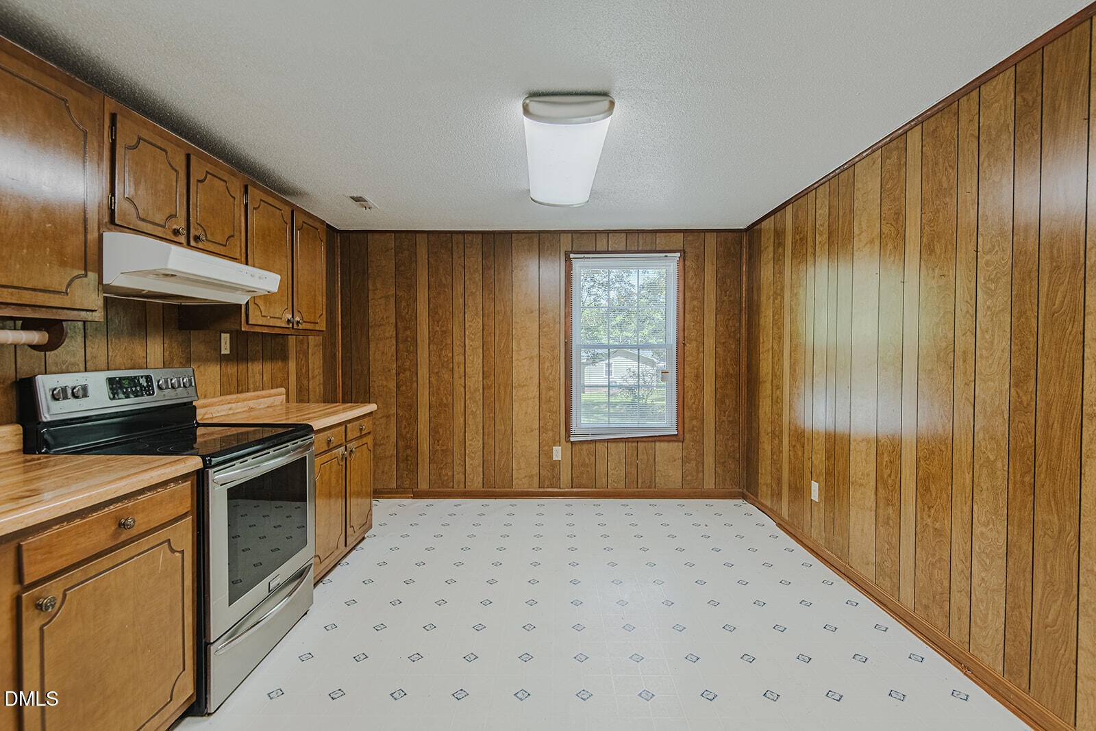 1302 Blacksmith Road Efland, NC 27243 - Photo 4 of 46 a kitchen with granite countertop wooden cabinets and stainless steel appliances