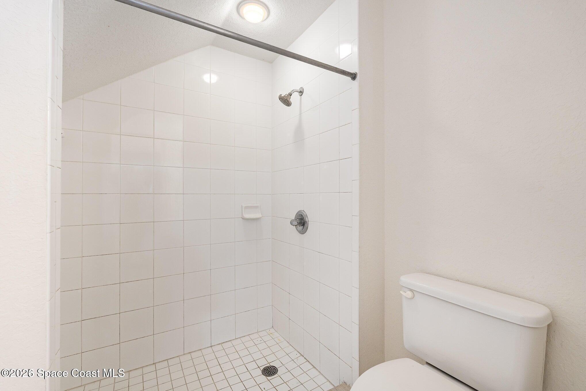 110 Colibri Way, Unit 106 Melbourne, FL 32901 - Photo 11 of 28 a bathroom with a shower and toilet
