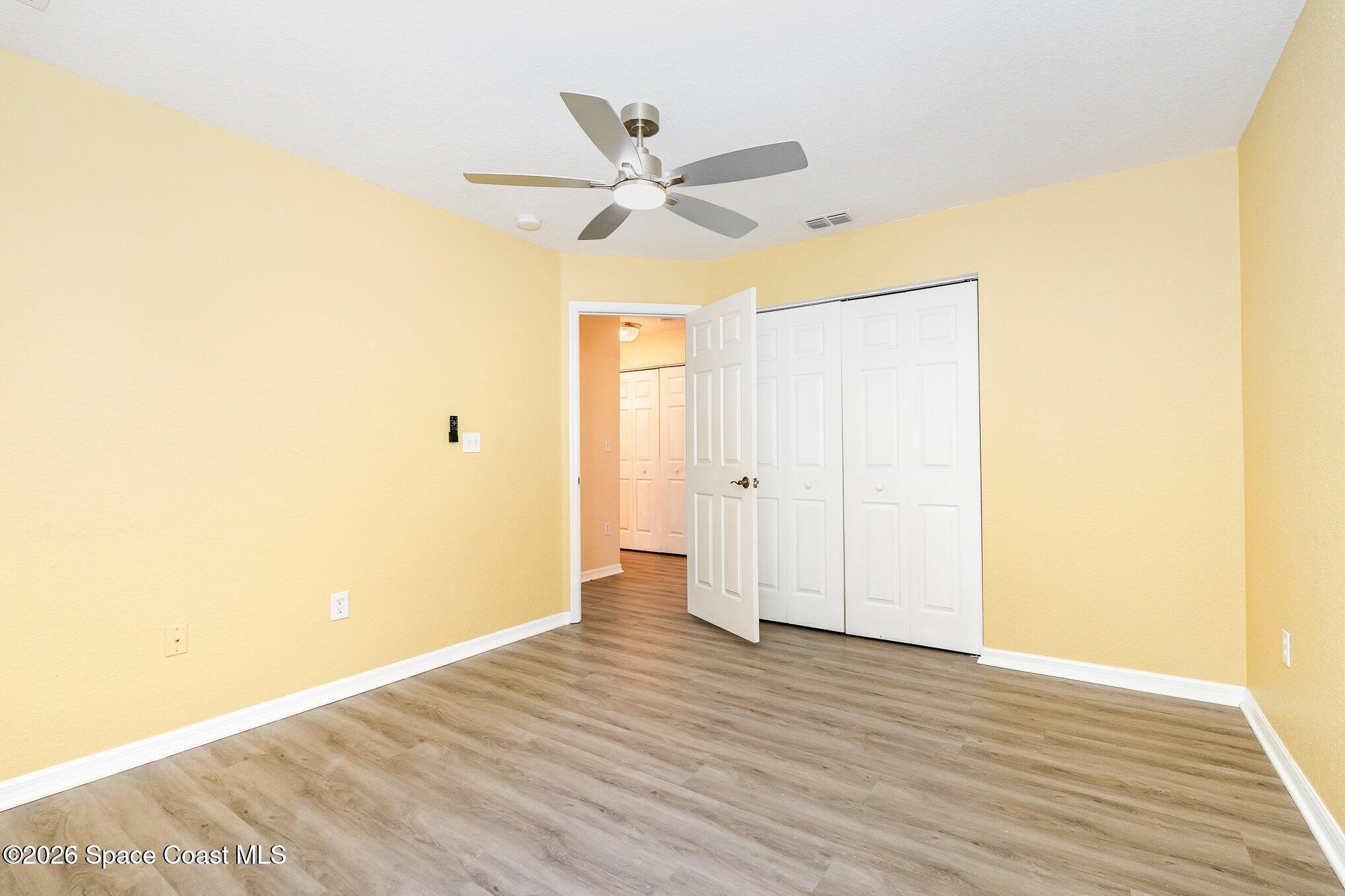 110 Colibri Way, Unit 106 Melbourne, FL 32901 - Photo 15 of 28 a view of a room with wooden floor and ceiling fan
