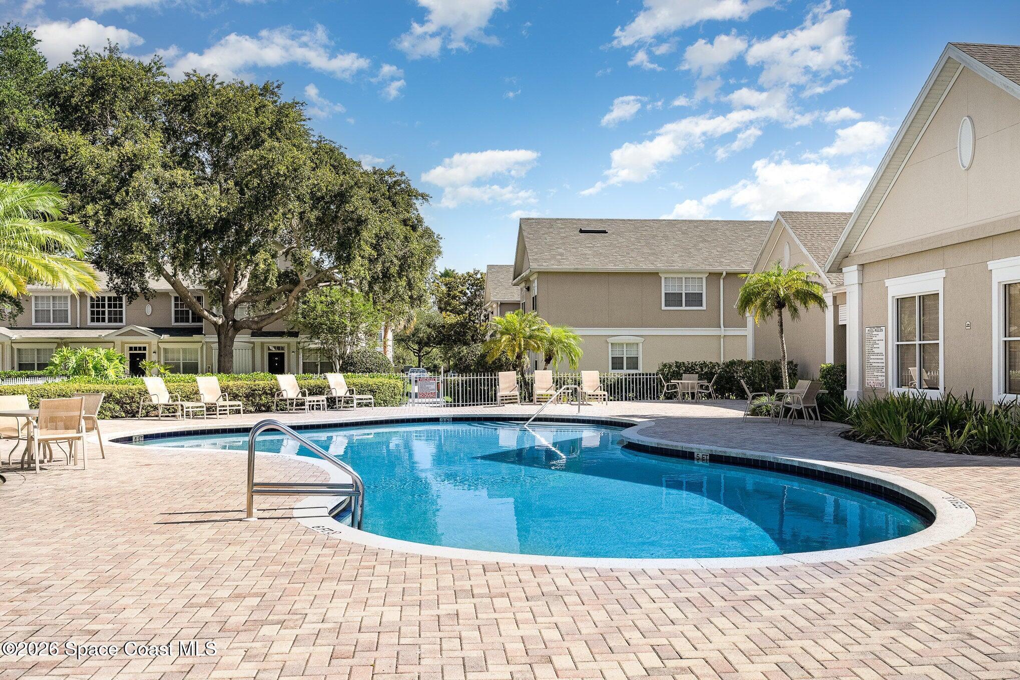110 Colibri Way, Unit 106 Melbourne, FL 32901 - Photo 21 of 28 a view of a swimming pool with outdoor seating