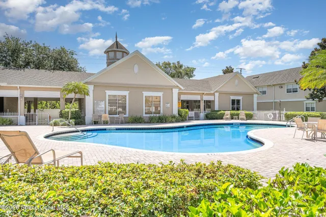 front view of a house with swimming pool and porch