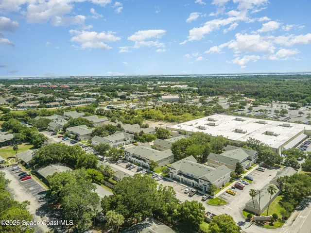 an aerial view of residential building and lake