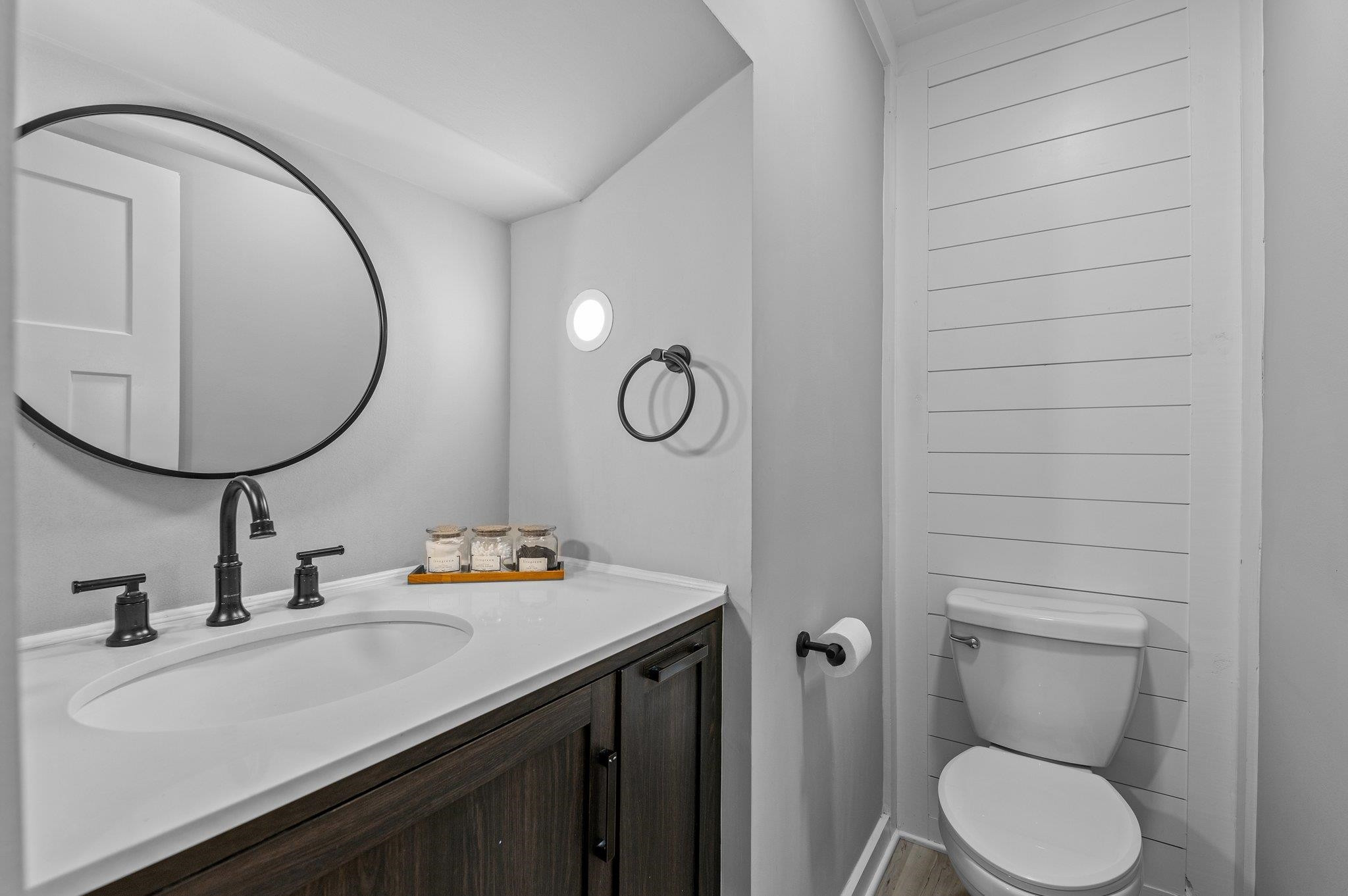 2037 Queen Charlotte Place Raleigh, NC 27610 - Photo 13 of 32 a bathroom with a toilet a sink and mirror