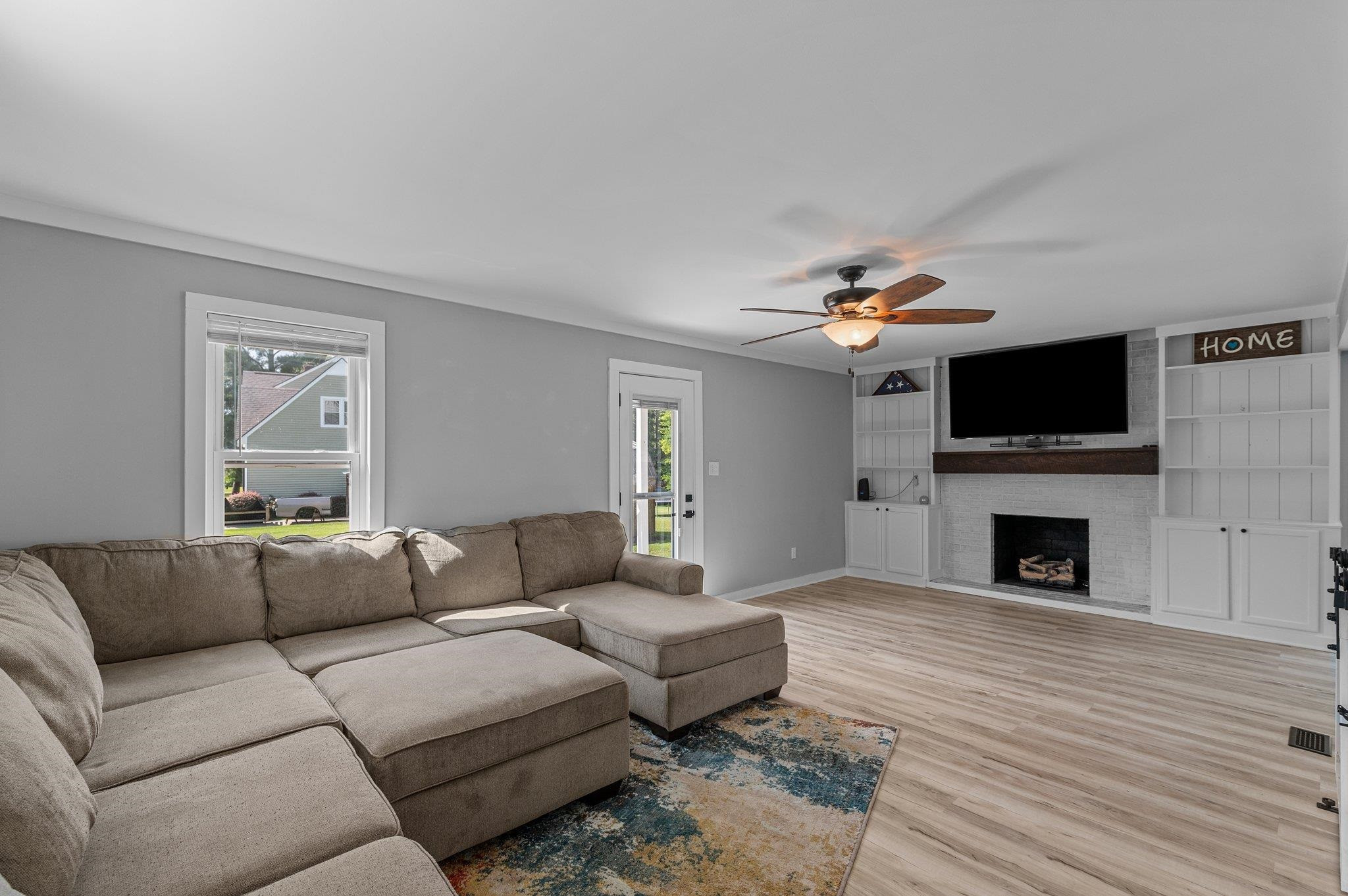 2037 Queen Charlotte Place Raleigh, NC 27610 - Photo 14 of 32 a living room with furniture a fireplace and a flat screen tv