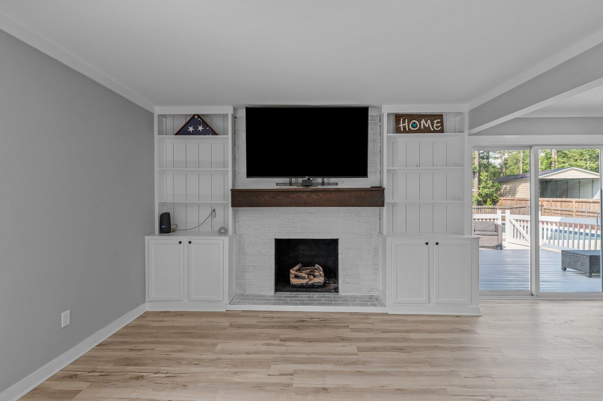 2037 Queen Charlotte Place Raleigh, NC 27610 - Photo 15 of 32 a living room with a fireplace and a flat screen tv