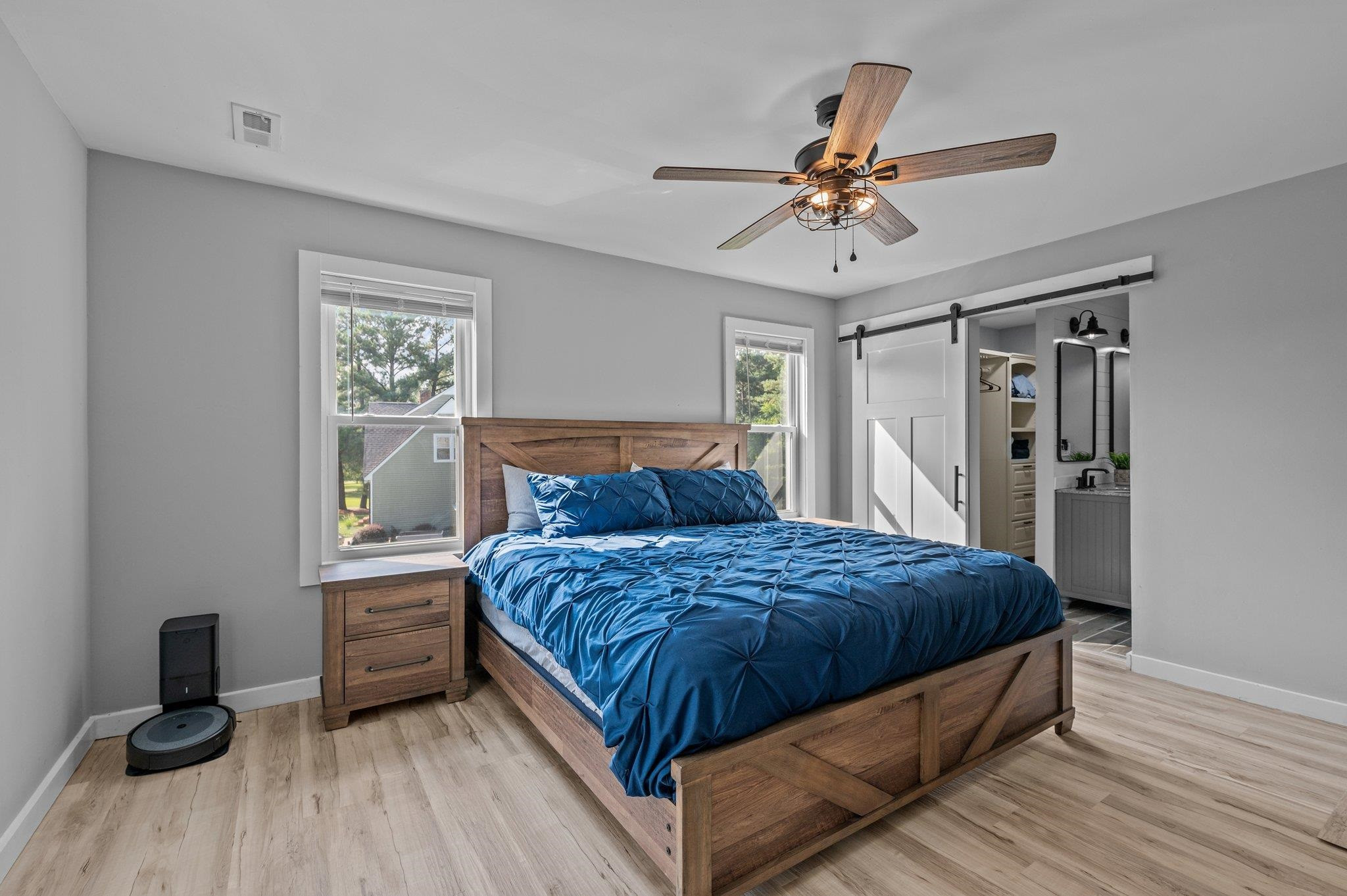 2037 Queen Charlotte Place Raleigh, NC 27610 - Photo 16 of 32 a bedroom with a bed and a chandelier