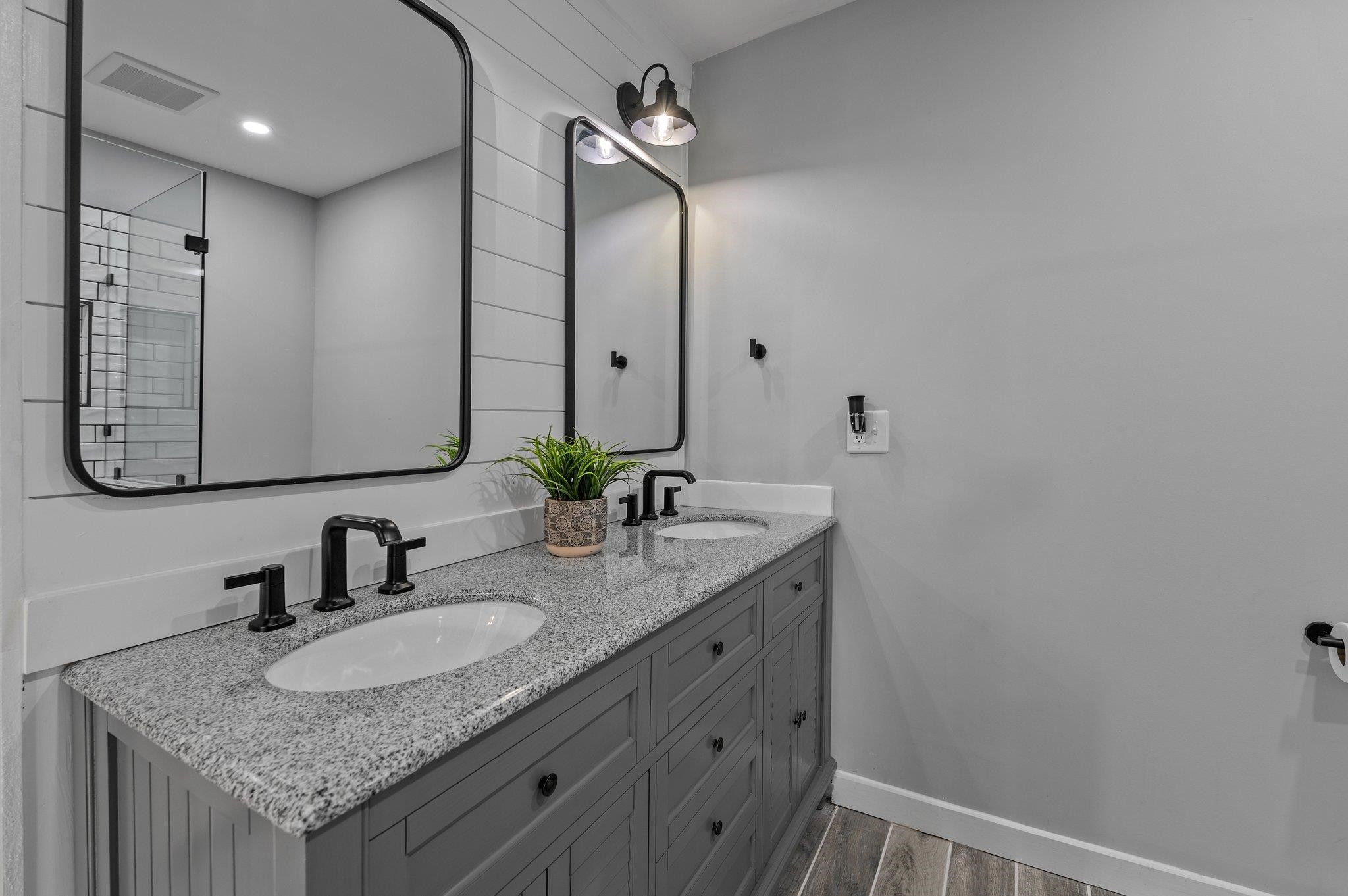2037 Queen Charlotte Place Raleigh, NC 27610 - Photo 18 of 32 a bathroom with a granite countertop sink and a mirror