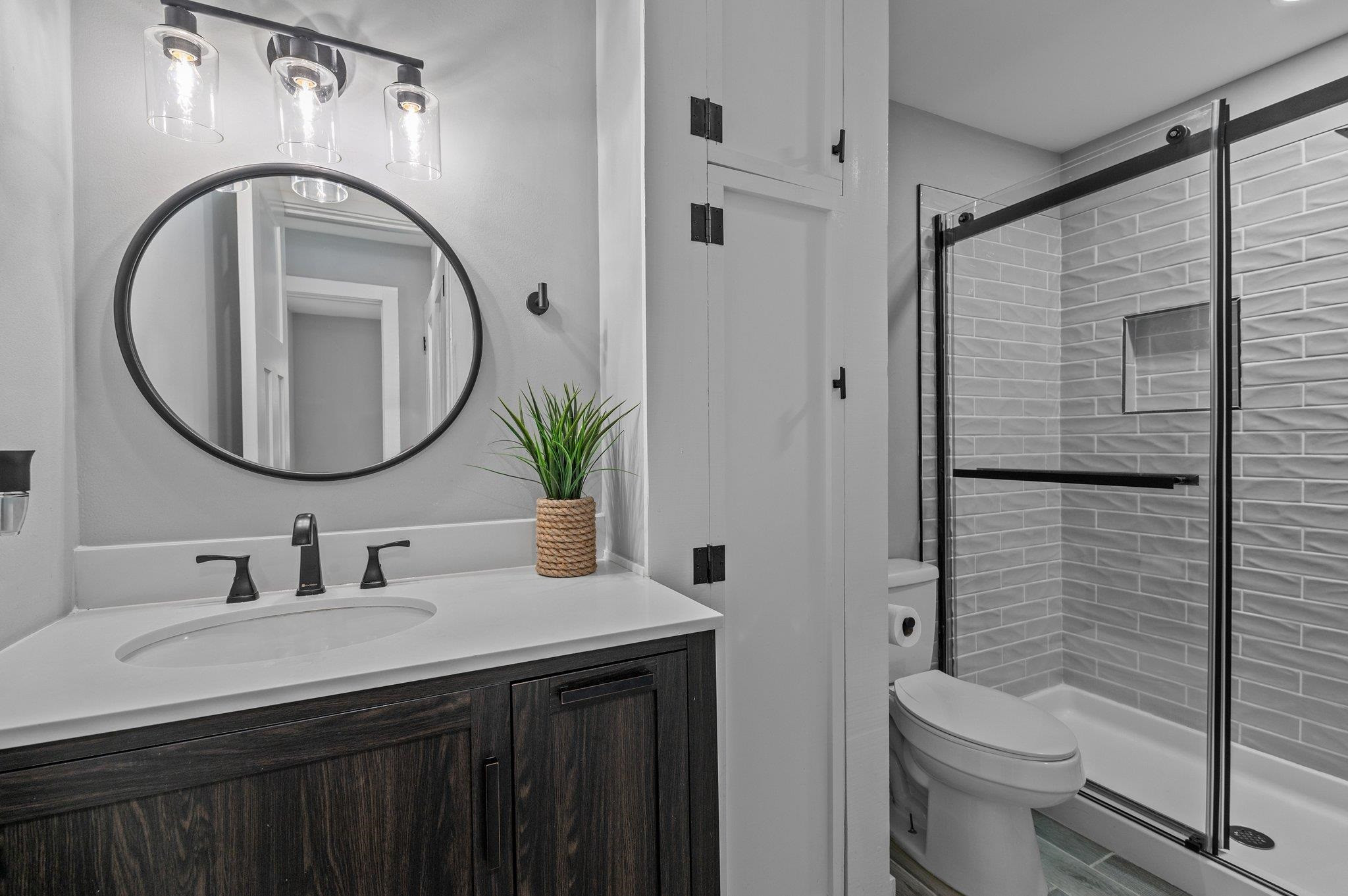 2037 Queen Charlotte Place Raleigh, NC 27610 - Photo 27 of 32 a bathroom with a toilet a sink and a mirror