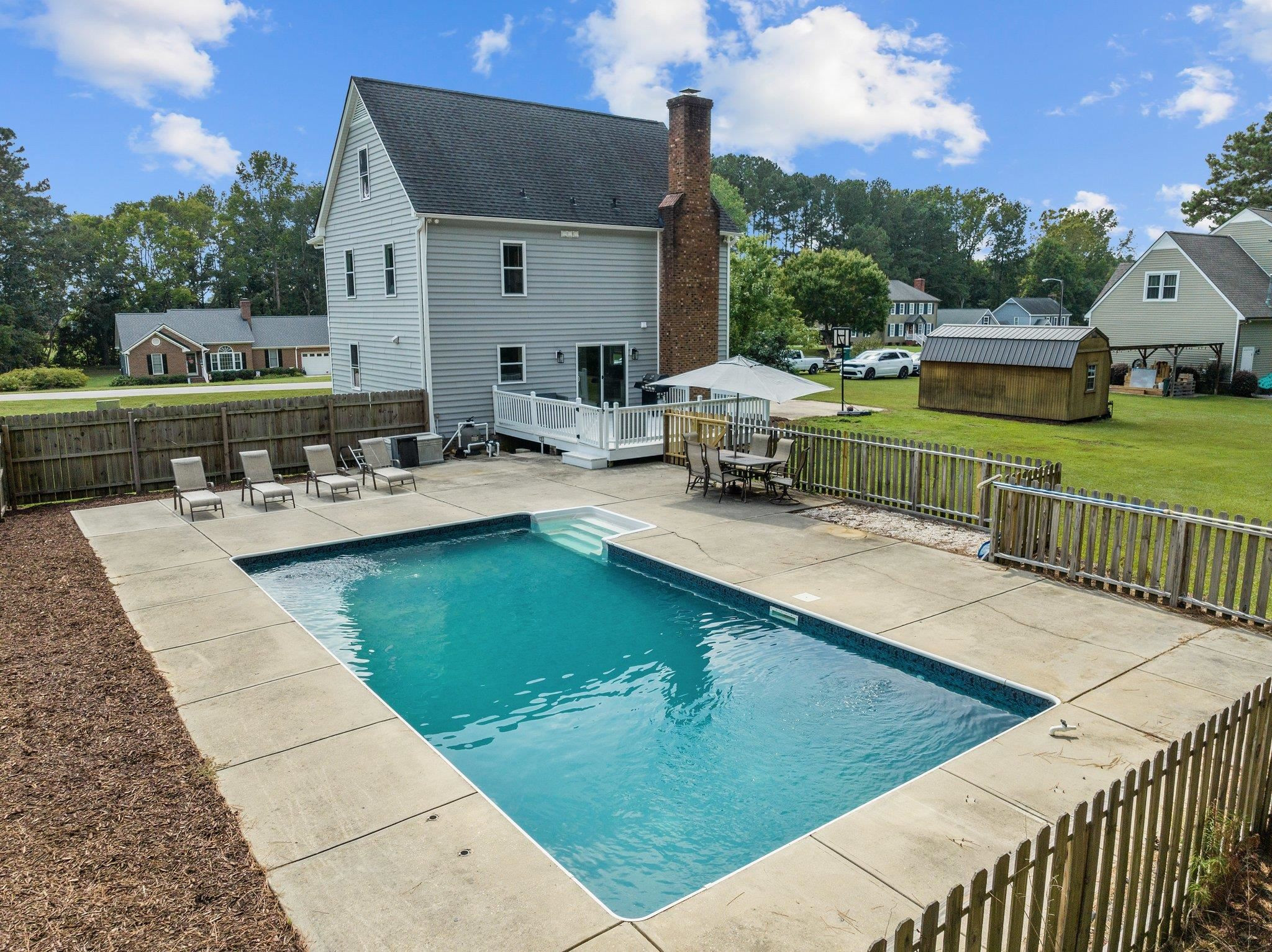 2037 Queen Charlotte Place Raleigh, NC 27610 - Photo 4 of 32 a view of a swimming pool with a patio