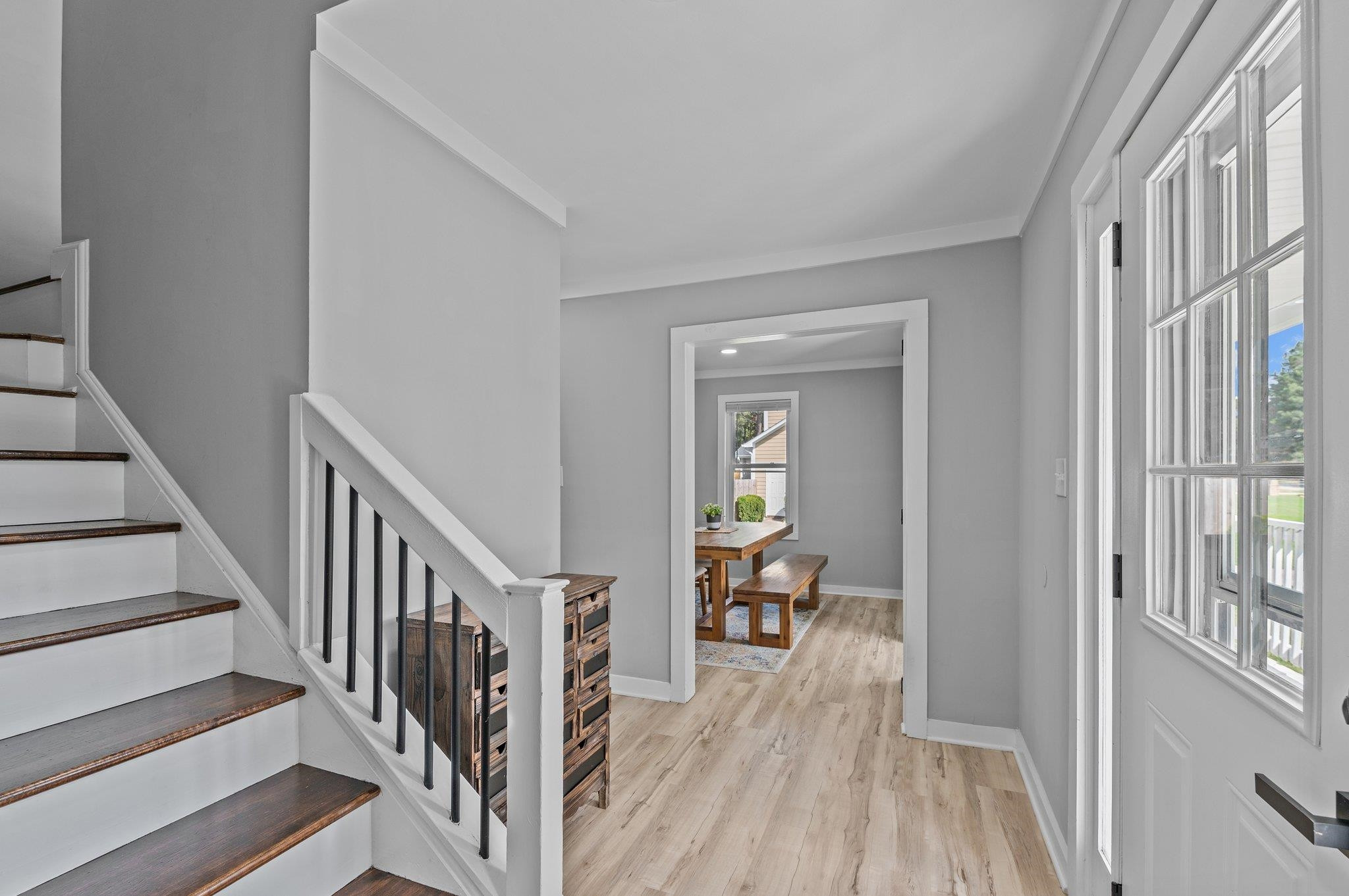 2037 Queen Charlotte Place Raleigh, NC 27610 - Photo 6 of 32 a view of a hallway with wooden floor and dining room view
