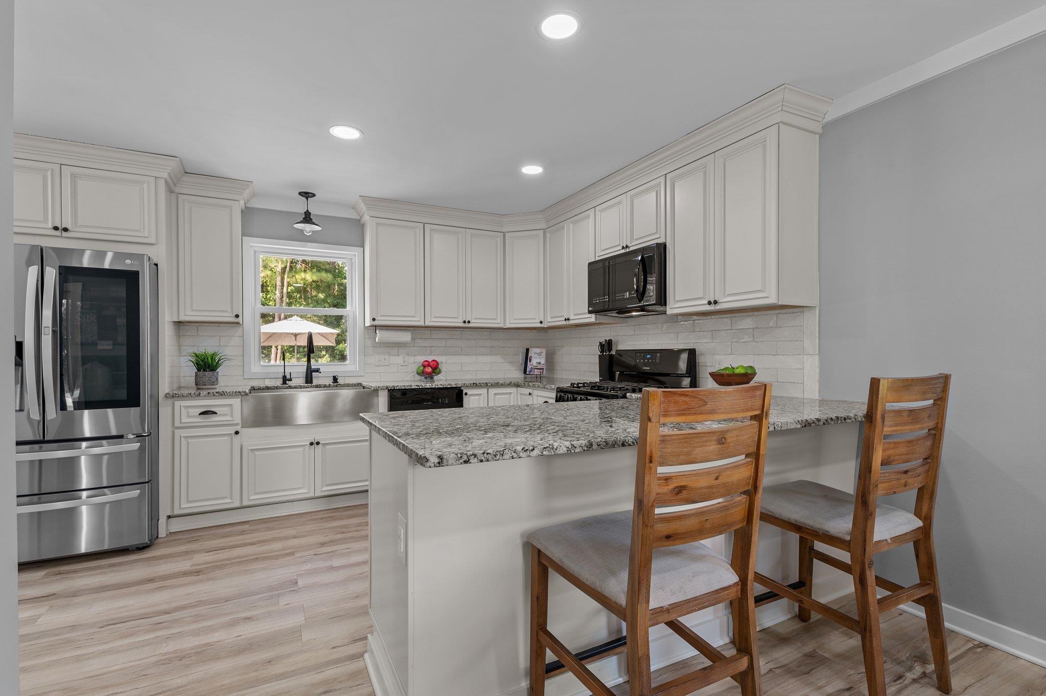 2037 Queen Charlotte Place Raleigh, NC 27610 - Photo 7 of 32 a kitchen with granite countertop white cabinets and stainless steel appliances