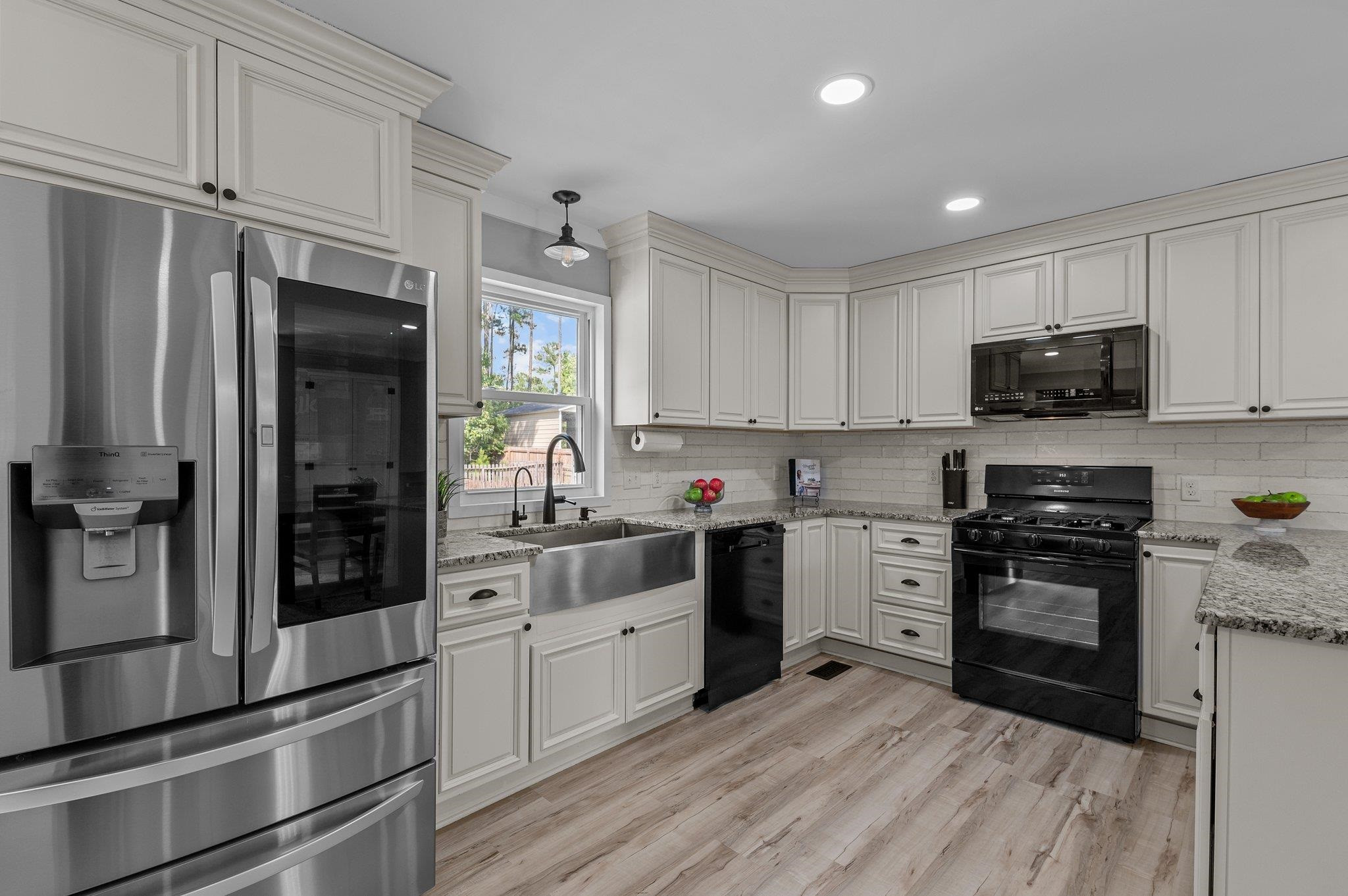 2037 Queen Charlotte Place Raleigh, NC 27610 - Photo 8 of 32 a kitchen with granite countertop a refrigerator stove and sink
