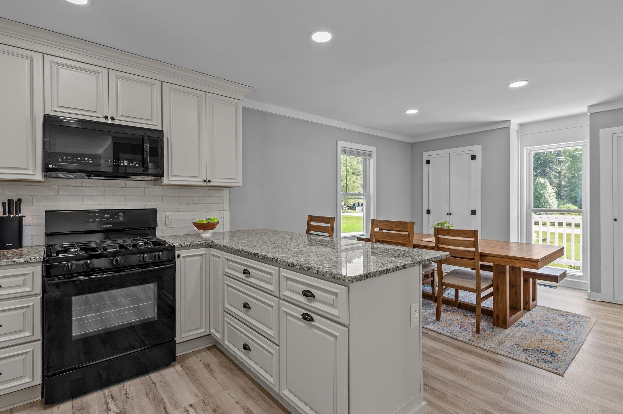 2037 Queen Charlotte Place Raleigh, NC 27610 - Photo 10 of 32 a kitchen with stainless steel appliances granite countertop a stove a sink and a microwave