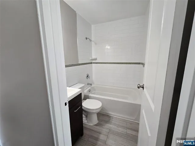 a bathroom with a bathtub and toilet