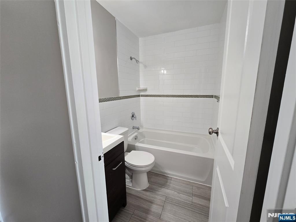 100 2nd Street, Unit 310 Hackensack, NJ 07601 - Photo 2 of 5 a bathroom with a bathtub and toilet