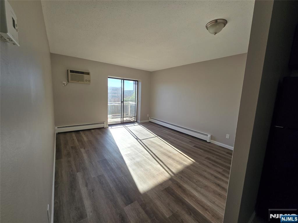 100 2nd Street, Unit 310 Hackensack, NJ 07601 - Photo 4 of 5 a view of wooden floor and windows in a room