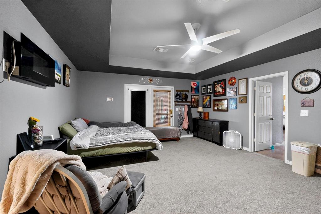 418 Hillside Drive Gainesville, TX 76240 - Photo 19 of 39 a bedroom with furniture and a flat screen tv