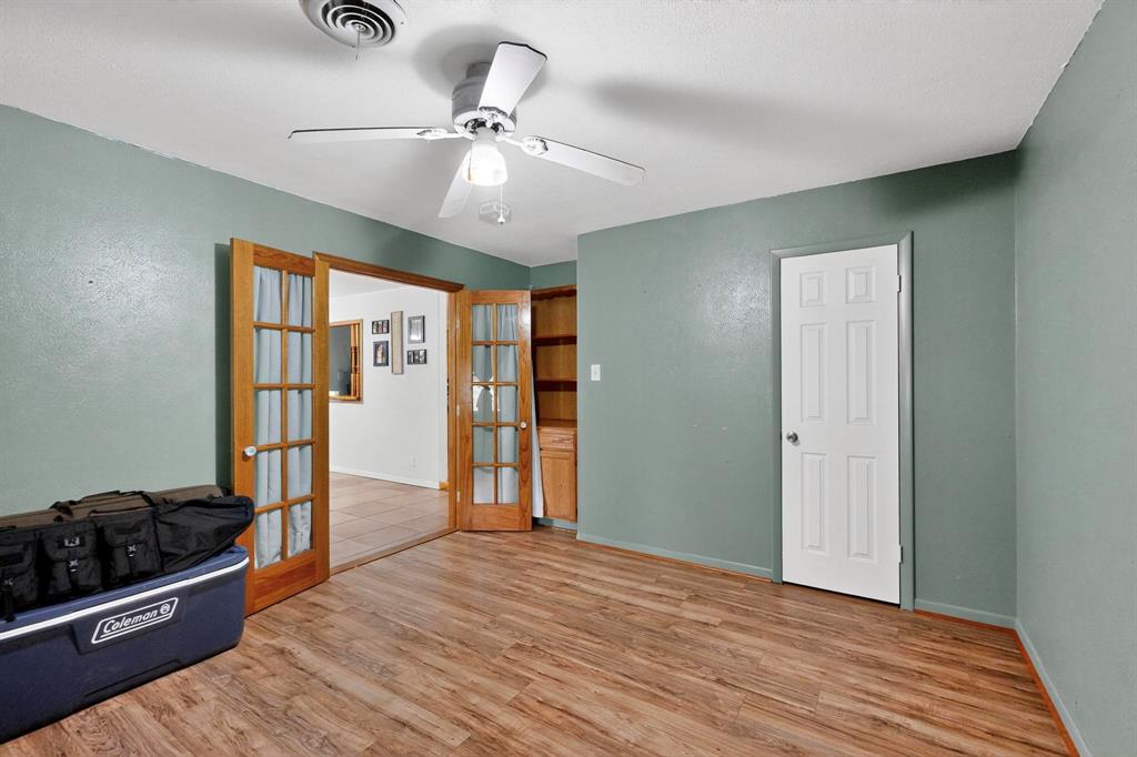 418 Hillside Drive Gainesville, TX 76240 - Photo 24 of 39 wooden floor in an empty room and a window