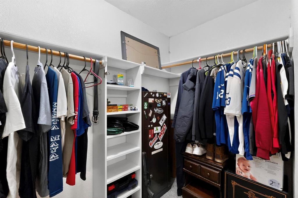 418 Hillside Drive Gainesville, TX 76240 - Photo 29 of 39 a view of walk in closet with clothes
