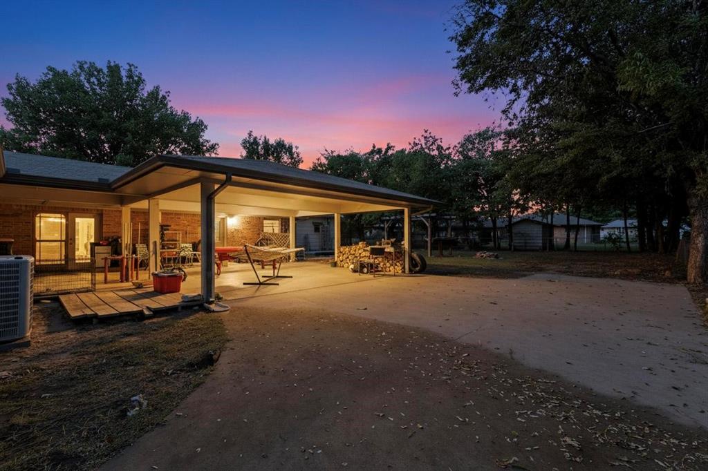 418 Hillside Drive Gainesville, TX 76240 - Photo 35 of 39 a front view of a house with a garden