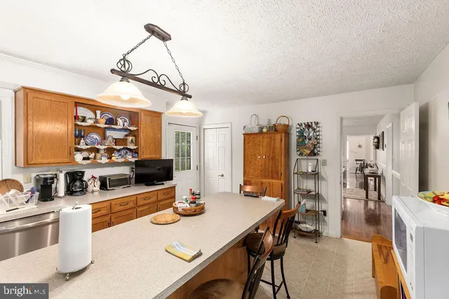 a view of a kitchen with a sink and a refrigerator