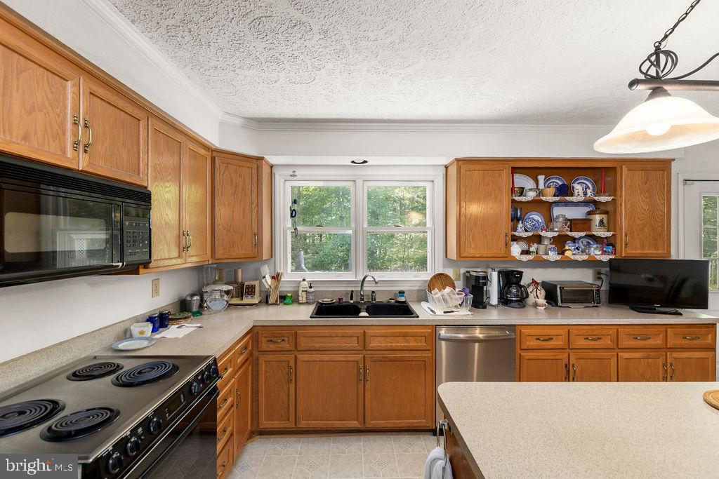 1115 Chapel Road Middletown, VA 22645 - Photo 28 of 54 a kitchen with a stove a sink and a microwave