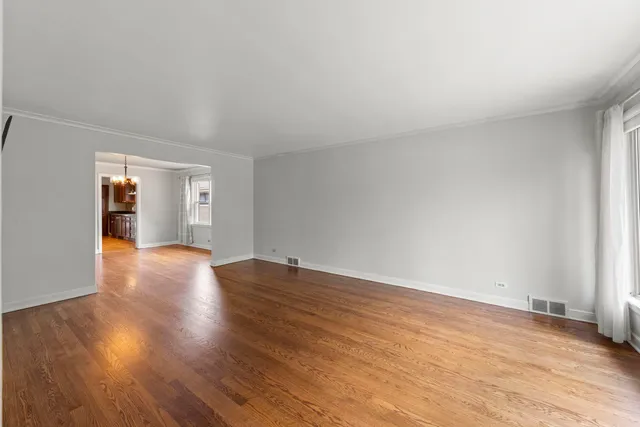 a view of an empty room and wooden floor