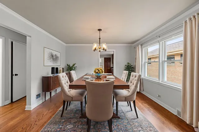 a dining room with furniture window and wooden floor