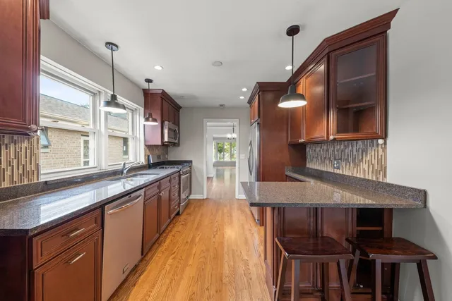 a kitchen with kitchen island a large island in the center windows and furniture