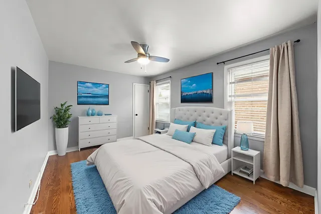 a bedroom with a large bed and a flat tv screen