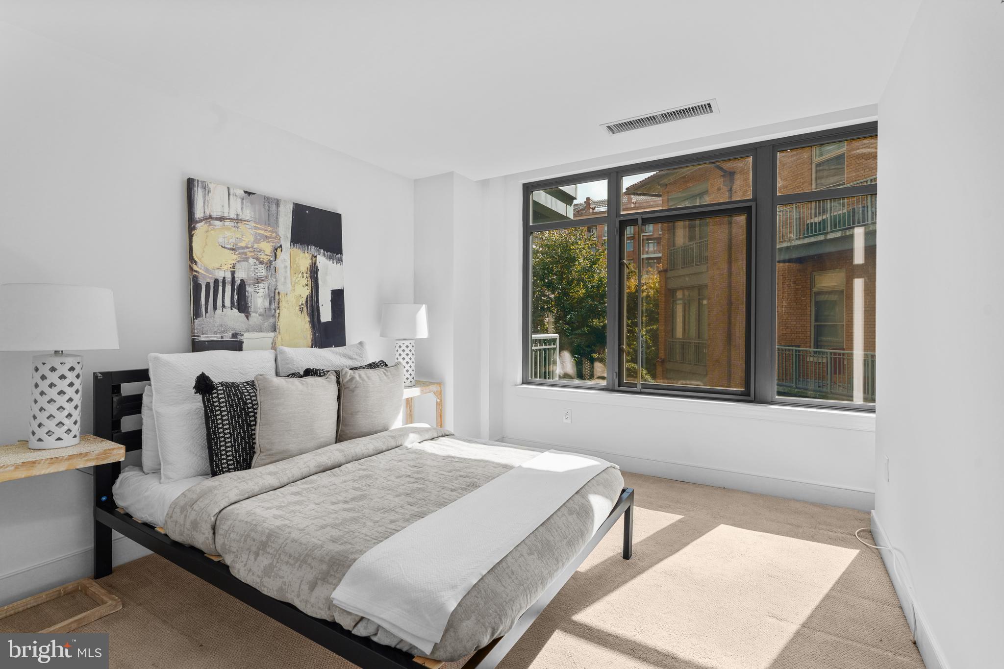 2425 L Street Northwest, Unit 431 Washington, DC 20037 - Photo 21 of 29 a bedroom with a large bed and a window