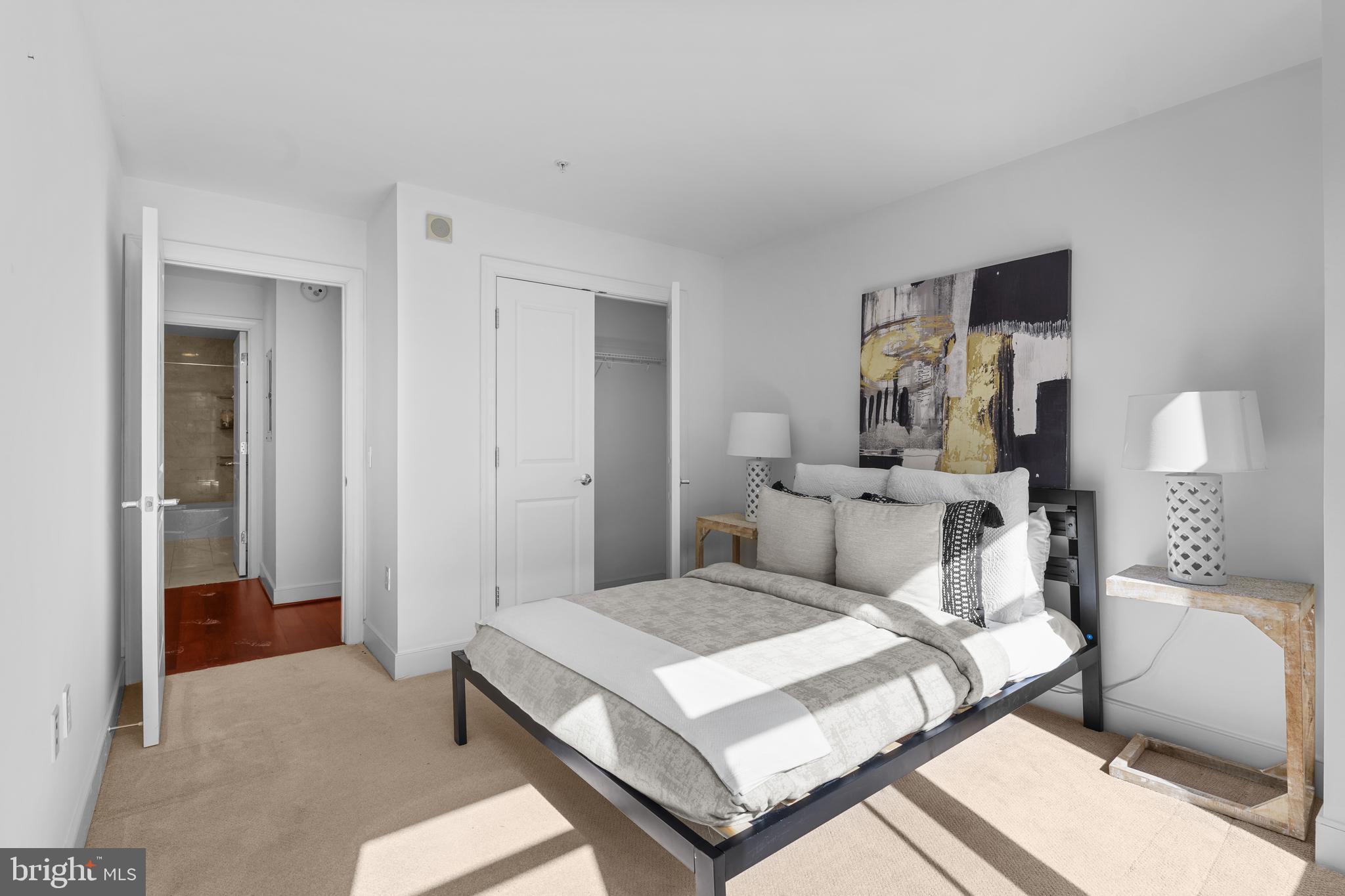 2425 L Street Northwest, Unit 431 Washington, DC 20037 - Photo 22 of 29 a bedroom with a bed and wooden floor