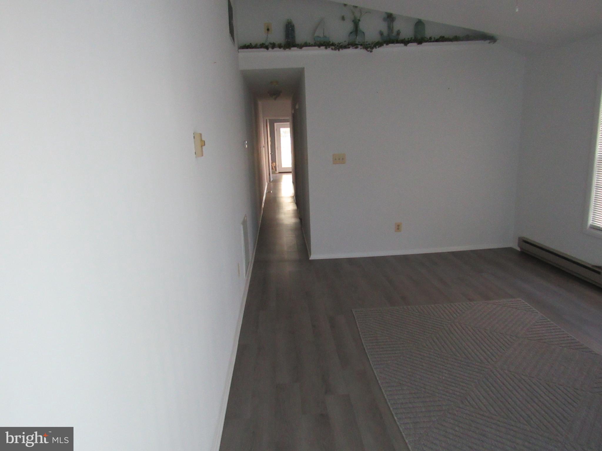 1015 Cold Spring Road Middle River, MD 21220 - Photo 7 of 28 an empty room with wooden floor and windows