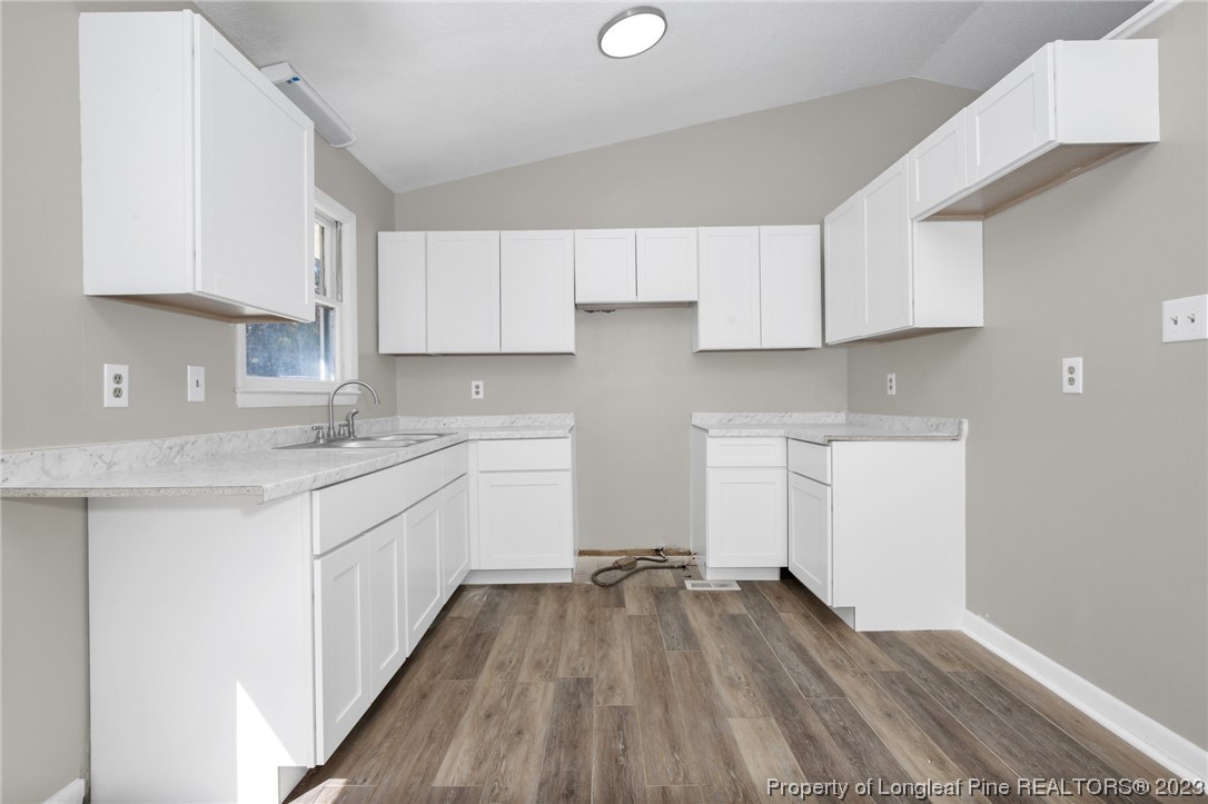 3319 Hedgemoor Circle Spring Lake, NC 28390 - Photo 13 of 30 a kitchen with a sink window and cabinets