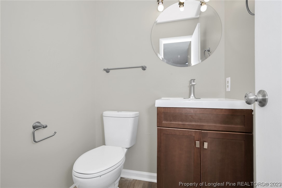 3319 Hedgemoor Circle Spring Lake, NC 28390 - Photo 18 of 30 a bathroom with a toilet sink vanity and mirror